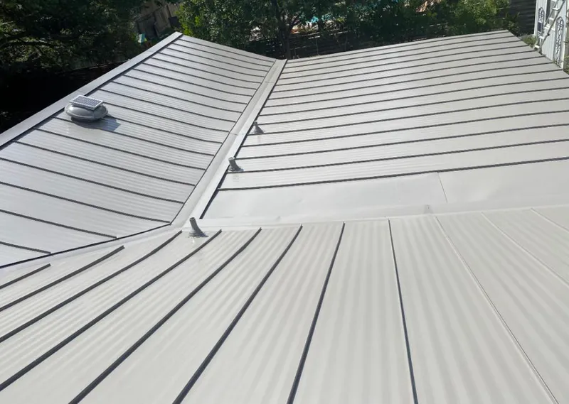 Solar attic fan installed on a metal roof for Roof Ventilation in Calera